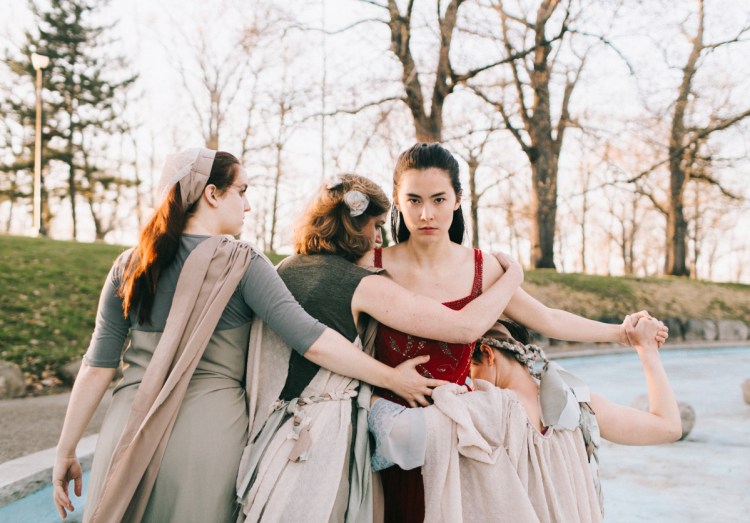Erica Murphy, in red, as Eurydice, with Hannah Daly, left, Casey Turner and Ella Mock as the three stones.