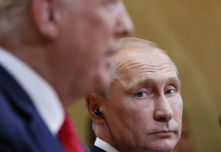 Russian President Vladimir Putin listens to President Trump in Helsinki, Finland in July.