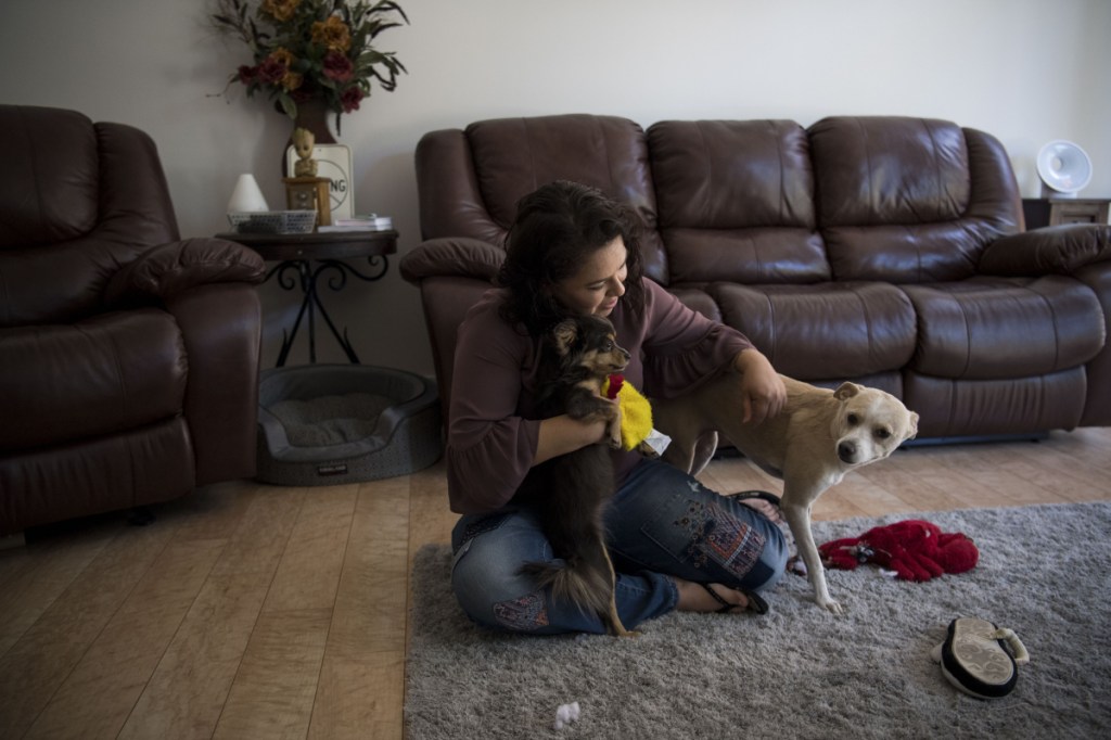 Ruby Torres plays with her dogs Angel and Dora. She was given custody of Angel during her divorce, but not her embryos.