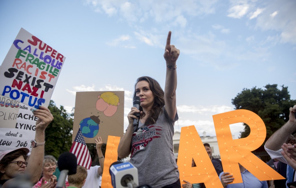 Actress Alyssa Milano speaks at a protest outside the White House on Tuesday following President Trump's controversial summit with Russian President Vladimir Putin a day earlier.