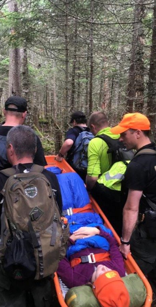 A team of emergency responders rescue Andrea Pincumbe, 21, of Asheville, N.C., from the Poplar Ridge lean-to atop Saddleback Mountain on Tuesday.