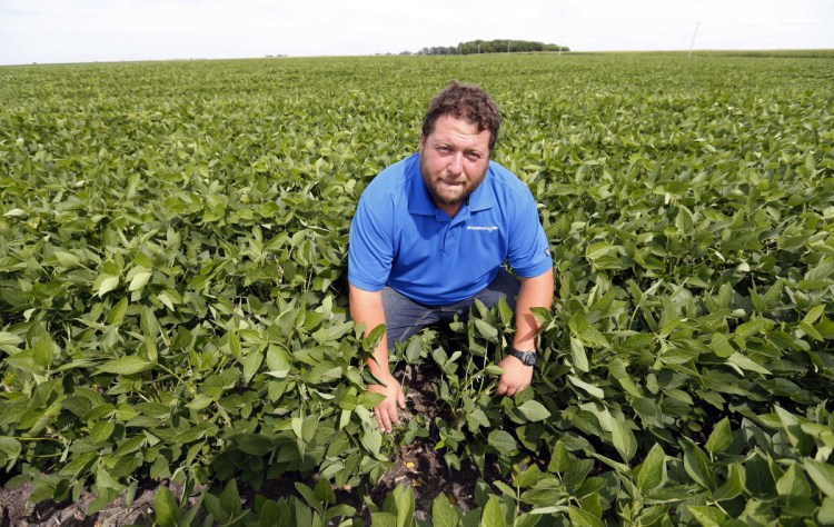 Farmer Michael Petefish poses in his soybean field at his farm near Claremont in southern Minnesota.