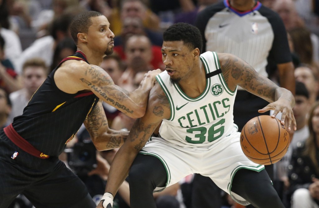 Boston's Marcus Smart, right, drives past Cleveland's George Hill during Game 6 of the NBA's Eastern Conference finals in May. (AP Photo/Ron Schwane)