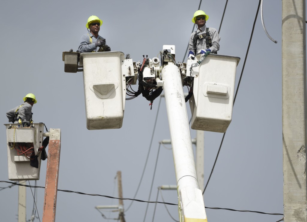 Workers patch up damaged distribution lines last October after Hurricane Maria hit Puerto Rico, causing widespread damage. As another hurricane season approaches, officials are still struggling to finish the work.