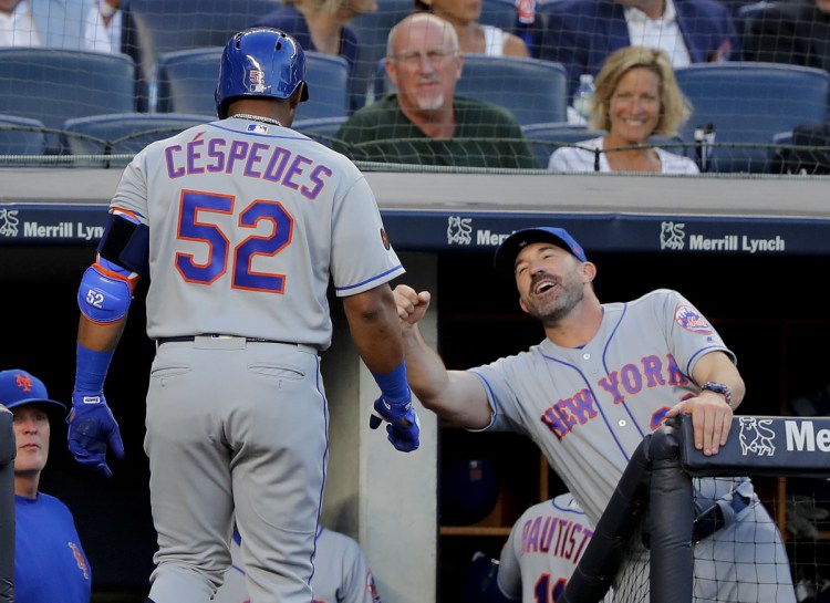 Yoenis Cespedes of the Mets is congratulated by Manager Mickey Callaway after hitting a home run against the Yankees Friday night in New York.