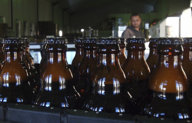 Freshly bottles of beer stand in the Darling Brewery in Darling, South Africa. The South African brewery appears to be the first in Africa to go carbon-neutral as more businesses across the continent adjust to climate change, and as consumers become more careful about the products they buy.