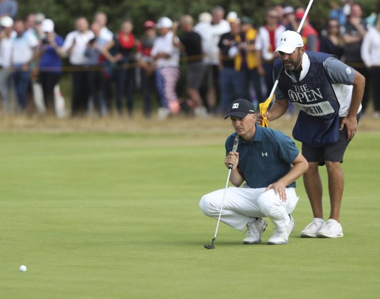 Jordan Spieth and his caddie, Michael Greller, line up a putt on the ninth hole during the third round of the British Open on Saturday.