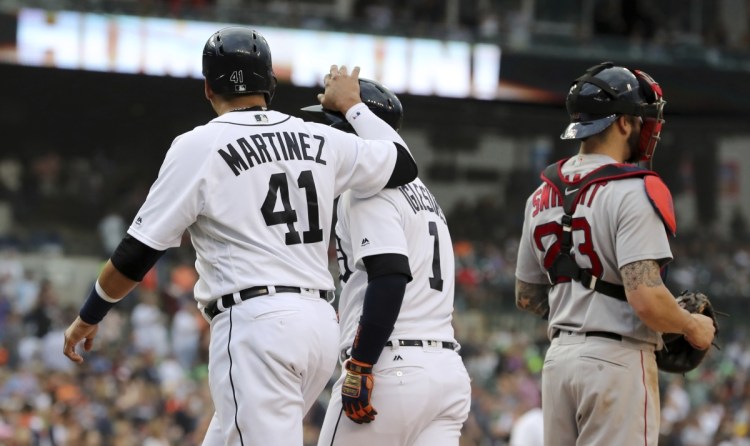 Tigers designated hitter Victor Martinez , left, congratulates Jose Iglesias after Iglesias hit a two-run home run against the Boston Red Sox on Saturday in Detroit. The Tigers won 5-0.