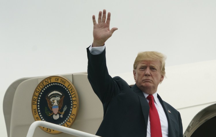 President Trump waves as he boards Air Force One at Morristown Municipal Airport, in Morristown, N.J., on Sunday en route to Washington after staying at Trump National Golf Club in Bedminster, N.J. Early Monday, Trump tweeted a threat at Iranian President Hassan Rouhani.