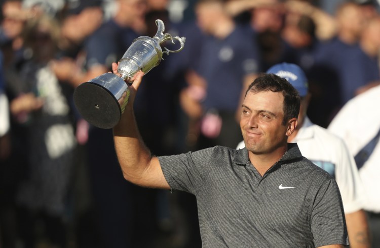 Francesco Molinari of Italy holds up the trophy after winning the British Open Golf Championship in Carnoustie, Scotland, Sunday July 22, 2018. (AP Photo/Peter Morrison)