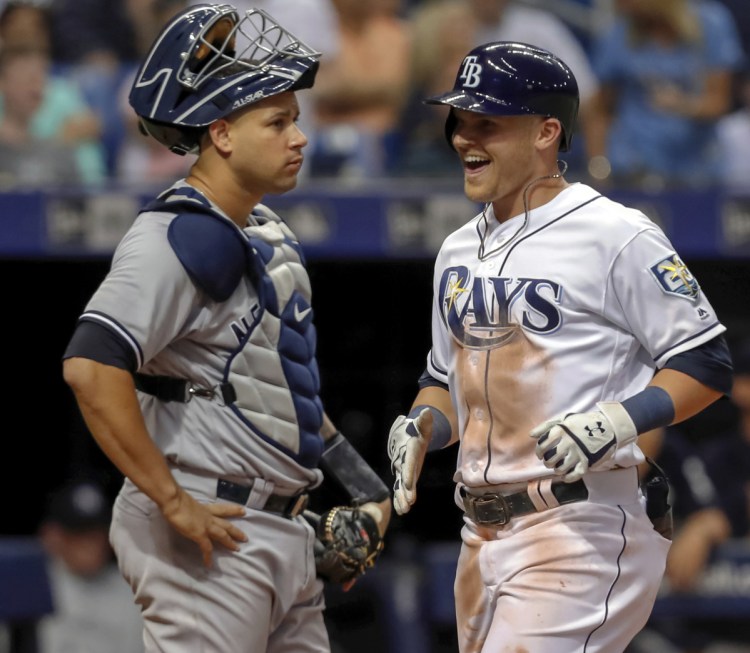Jake Bauers of the Tampa Bay Rays celebrates Monday night after crossing home plate in front of New York Yankees catcher Gary Sanchez following his three-run homer in the fifth inning of Tamp Bay's 7-6 home win.