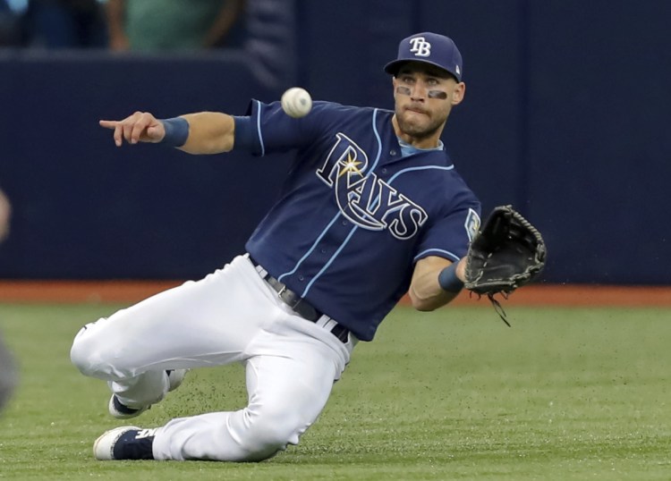 Rays center fielder Kevin Kiermaier makes a sliding catch to put out Didi Gregorius of the Yankees in the sixth inning Wednesday in St. Petersburg, Fla. Kiermaier also hit a go-ahead, two-run homer to help Tampa Bay beat New York 3-2 for a series win.
