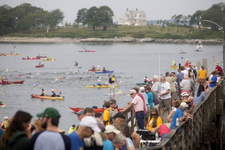 A crowd watches from the dock as the swimmers take off from Peaks Island during  the 36th annual Peaks to Portland swim in 2017.