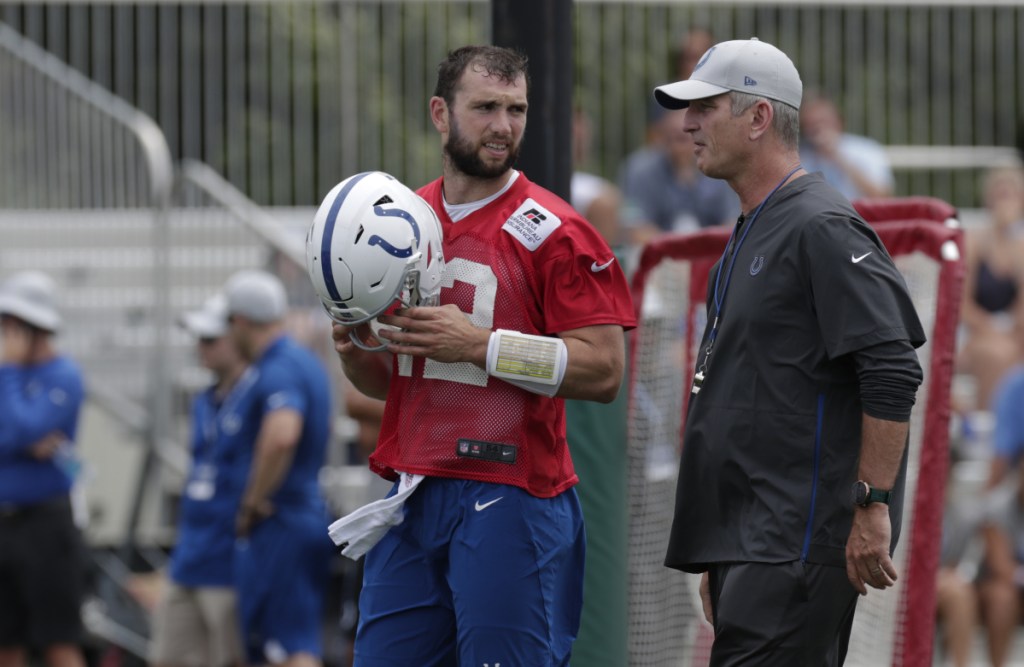 Indianapolis quarterback Andrew Luck talks with Coach Frank Reich on the first day of practice Thursday in Westfield, Ind.