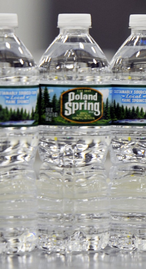 HOLLIS, ME - JUNE 21: Bottles of Poland Spring water on a conveyer belt in the Hollis facility Tuesday, June 21, 2016. (Photo by Shawn Patrick Ouellette/Staff Photographer)