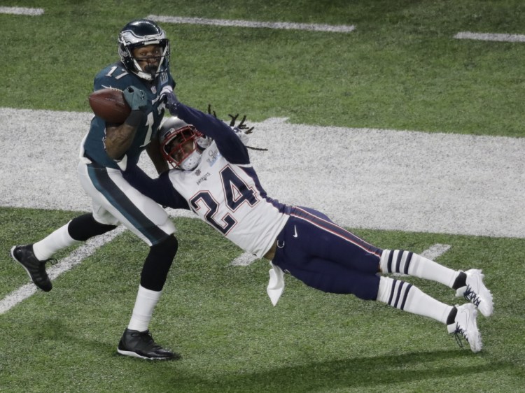 New England Patriots cornerback Stephon Gilmore breaks up a pass intended for Philadelphia Eagles wide receiver Alshon Jeffery during the first half of the NFL Super Bowl 52 football game Sunday, Feb. 4, 2018, in Minneapolis. The pass was later incepted by New England Patriots strong safety Duron Harmon. (AP Photo/Eric Gay)