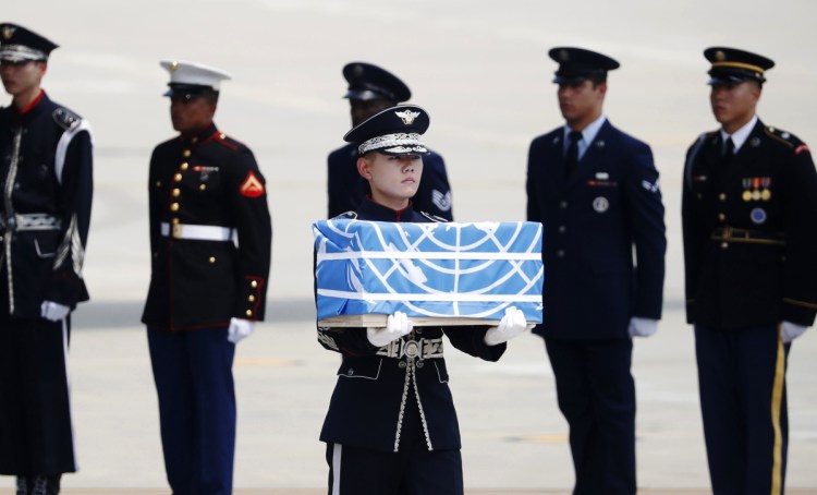 A soldier carries a casket containing the remains of a U.S. soldier who was a casualty of the Korean War during a ceremony Friday at Osan Air Base in Pyeongtaek, South Korea.