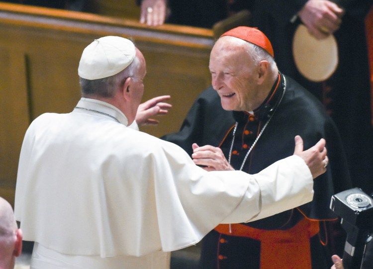 Pope Francis embraces Cardinal Theodore McCarrick at the Cathedral of St. Matthew the Apostle in Washington in 2015. The pope has accepted McCarrick's offer to resign from the College of Cardinals following allegations of sexual abuse, including one involving an 11-year-old boy, the Vatican said Saturday.