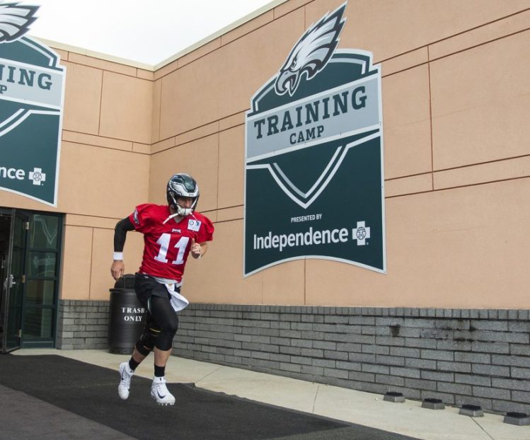 Philadelphia quarterback Carson Wentz runs out of the facility during practice on Thursday in Philadelphia.