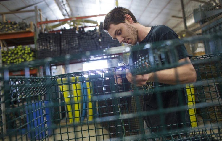 Dustin Chamberlain assembles the cage of an offshore lobster trap at Friendship Trap Co. "If the steel tariffs don't hit us, the lobster tariffs will," the company's owner, Chris Anderson, recently told the Press Herald.