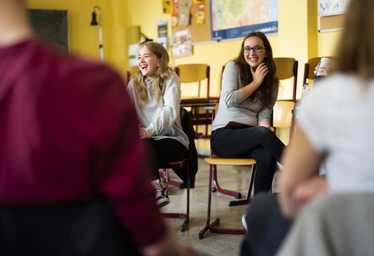 Laura Schulmann, center left, and Sophie Steiert field questions from students about Jewish daily life at a high school in Luckau, Germany. They want to change perceptions and challenge stereotypes.