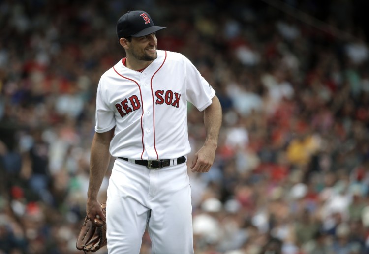 Nathan Eovaldi of the Boston Red Sox smiles as he steps off the mound after pitching against the Minnesota Twins at Fenway Park on Sunday. (AP Photo/Steven Senne)