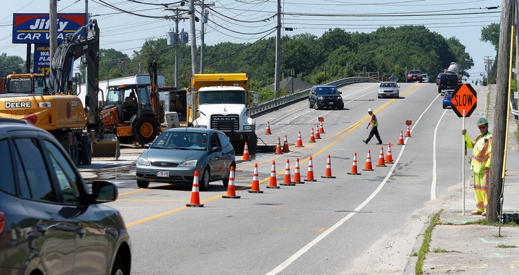 Traffic is flowing, though a little more slowly, in both lanes of Main Street/Route 1 in South Portland Thursday as repairs to a broken water continue. 