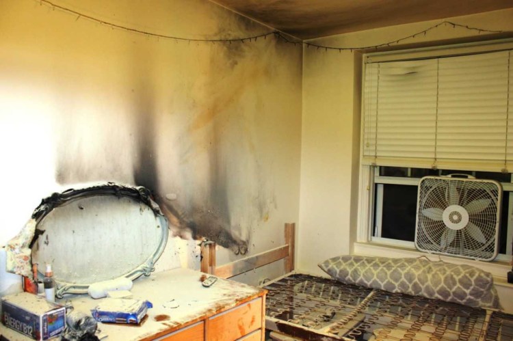 The walls and ceiling of a Colby College dorm room appear black and damaged from the fire and smoke that broke out early Tuesday morning. A student living in the room told investigators that she fell asleep after lighting a candle.