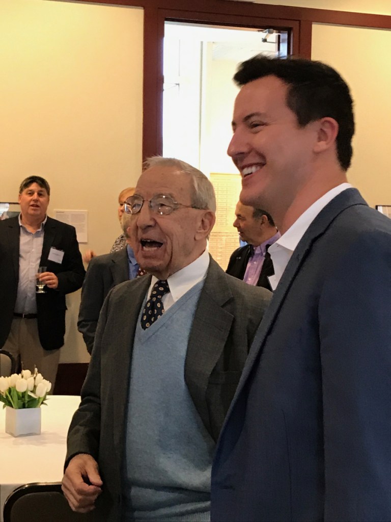 John "Swisher" Mitchell, left, enjoys a laugh with Colby College alum Mac Simpson duringa ceremony that endowed the Colby men's basketball assistant coaching position in his name. Mitchell died Wednesday.