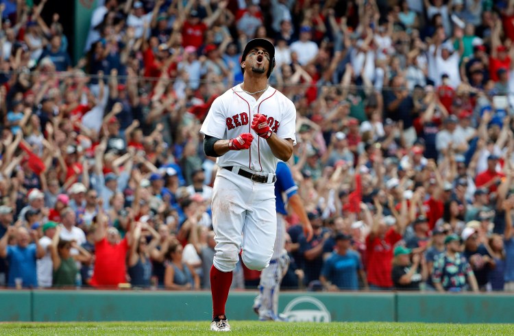 Boston's Xander Bogaerts shouts while rounding the bases after hitting a grand slam in the 10th inning of the Red Sox' 6-2 win over the Toronto Blue Jays on Saturday in Boston.