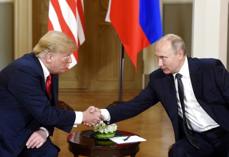 President Trump and Russian President Vladimir Putin shake hands during their meeting in the Presidential Palace in Helsinki on Monday.