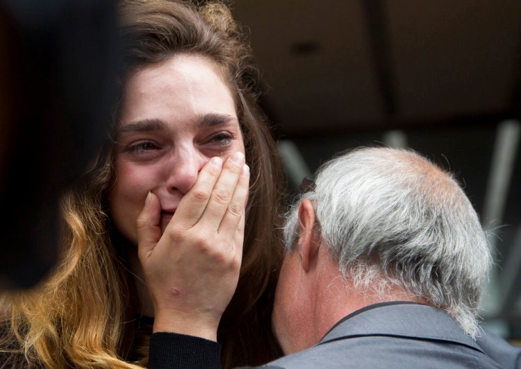 New York Daily News staff reporter Chelsia Rose Marcius cries as she is hugged by staff photographer Todd Maisel after they were both laid off, Monday.