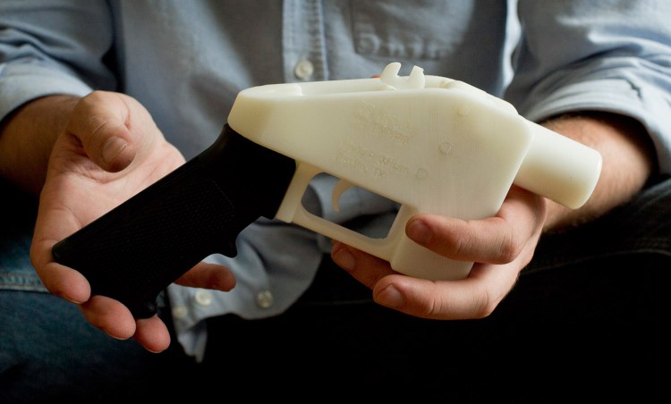 Cody Wilson holds what he calls a Liberator pistol that was completely made on a 3-D-printer at his home in Austin, Texas, in 2013. Eight states filed suit Monday against the Trump administration over its decision to allow a Texas company to publish downloadable blueprints for a 3D-printed gun.