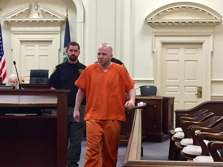 Derek Poulin is escorted into a courtroom at York County Superior Court in Alfred on Tuesday. He is seeking to have his life sentence reduced. 