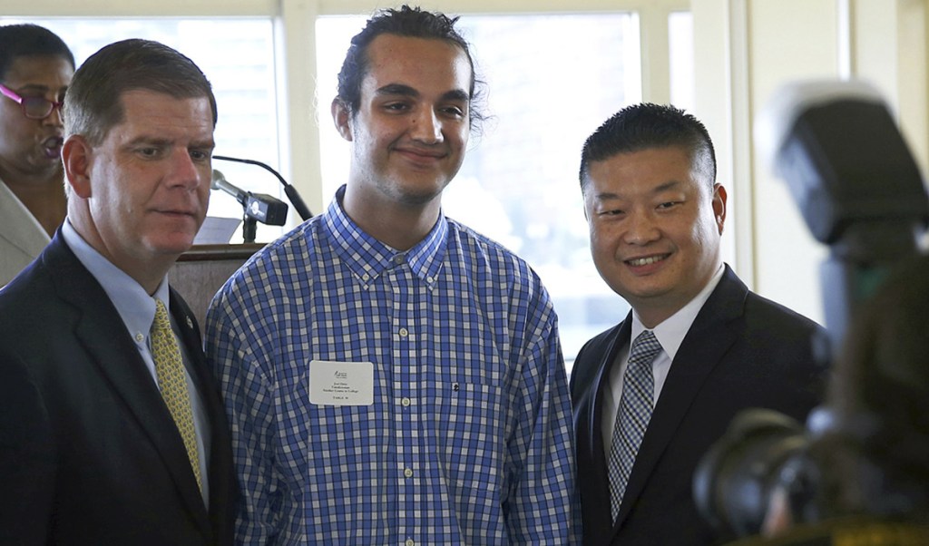 Joel Ortiz, center, poses with Mayor Marty Walsh, left, and school Superintendent Tommy Chang at a lunch for school valedictorians in Boston in 2016. Ortiz was arrested on July 12 on suspicion of hacking personal cell phones and stealing millions of dollars in digital currency.