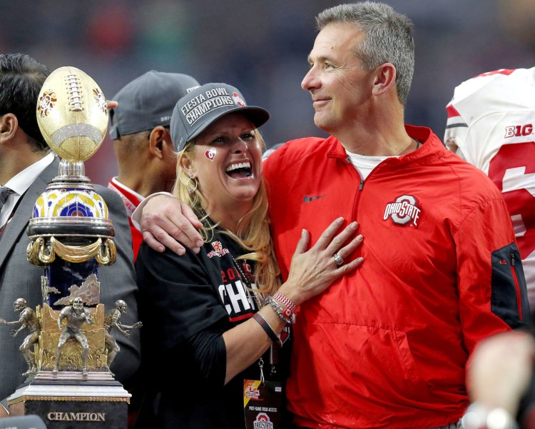 An assistant coach's wife told Shelley Meyer, left, she had been assaulted by her husband, a member of Urban Meyer's staff at Ohio State. Meyer says he did not know about that conversation. The school put him on leave and is investigating the incident.