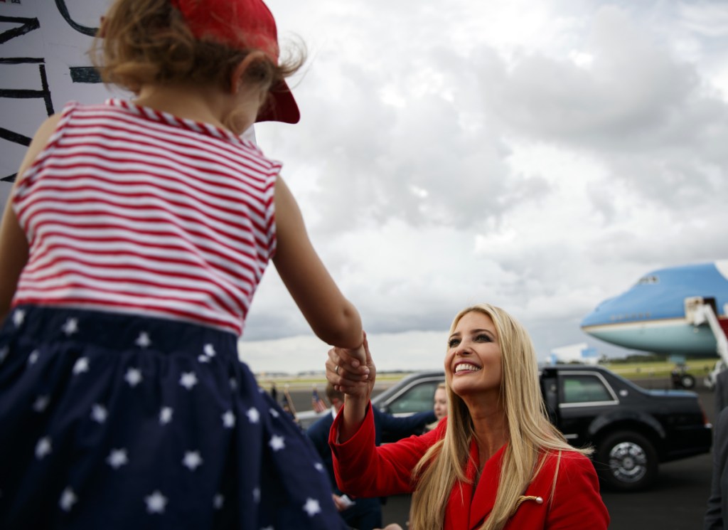 Ivanka Trump greets a child at Tampa International Airport on Tuesday. Trump says she disagrees with the president's attacks on journalists as the "enemy of the people."