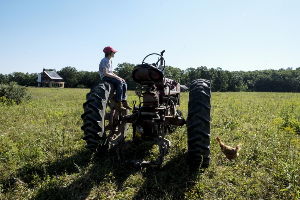 Silas Yates, 11, hangs out on his father's tractor at Broomgrass in Gerrardstown, W.Va., on July 19, 2018. MUST CREDIT: Washington Post photo by Bonnie Jo Mount.