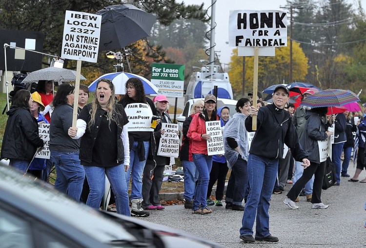 Striking FairPoint workers picket at the corner of Davis Farm Road and Riverside Street in Portland in October 2014. FairPoint's successor, Consolidated Communications, and the phone workers' union are now trying to reach a new contract agreement by midnight Saturday.
