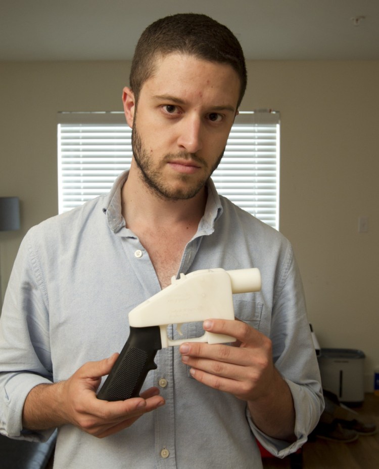Cody Wilson, founder of Defense Distributed, shows a plastic handgun made on a 3-D printer at his home.