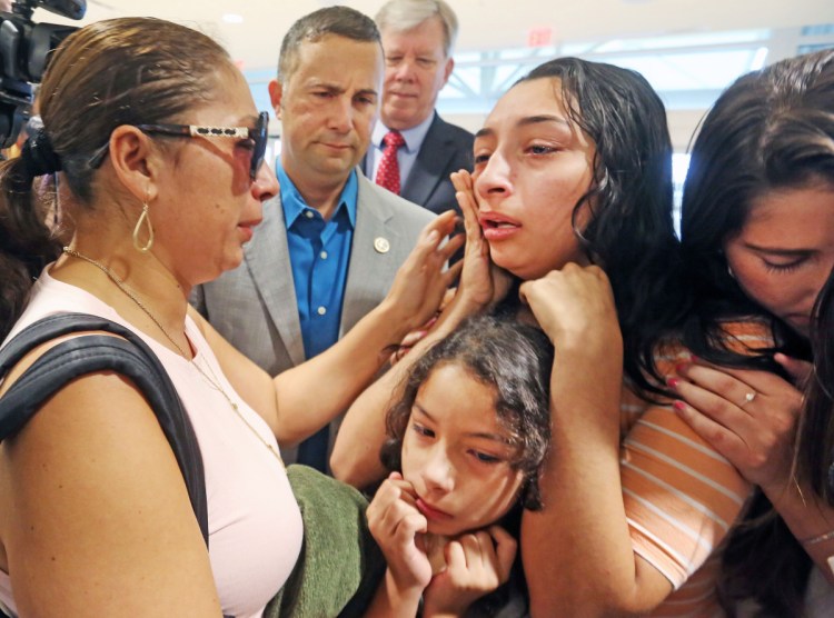 Alejandra Juarez, 38, says goodbye to her daughters Pamela, 16, top, and Estela, 8, at the Orlando International Airport on Friday. Juarez, who is in the U.S. illegally, ran out of options to remain here and was deported to Mexico. U.S. immigration officials denied her stay of removal request last week.