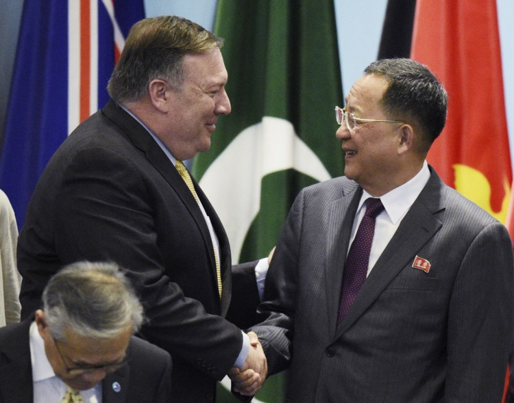 U.S. Secretary of State Mike Pompeo, left, greets North Korea's foreign minister, Ri Yong-ho, at the 25th ASEAN conference in Singapore on Saturday. After saying he foresaw "many productive conversations" with the U.S. over nuclear disarmament, Ri later criticized the U.S. for insisting on keeping sanctions in place.
