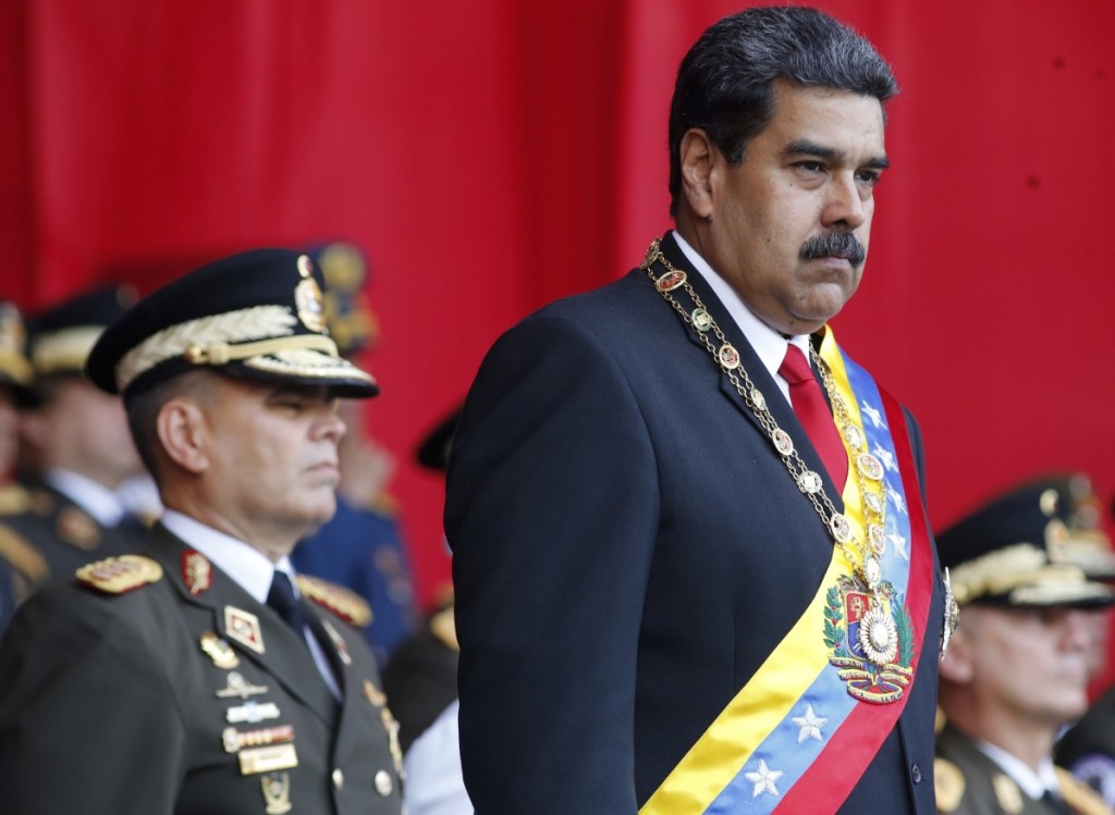 Associated Press/Ariana Cubillos
FILE - In this  May 24, 2018 file photo, Venezuela's President Nicolas Maduro watches a military parade, alongside his Defense Minister Vladimir Padrino Lopez, behind, at Fort Tiuna in Caracas, Venezuela on May 24. State television in Venezuela showed President Maduro abruptly cutting short a speech on Saturday, Aug. 4, causing hundreds of soldiers present to break ranks and scatter.(AP Photo/Ariana Cubillos, File)