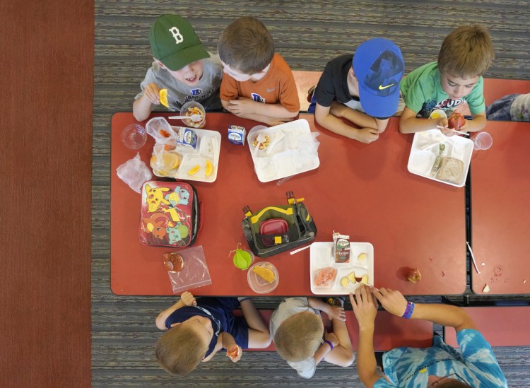 Children in the Buxton summer recreational program eat lunch at Buxton Center Elementary School cafeteria last month. About one in five kids in Maine struggle with food insecurity, more than in any other New England state and more than the average across the United States.