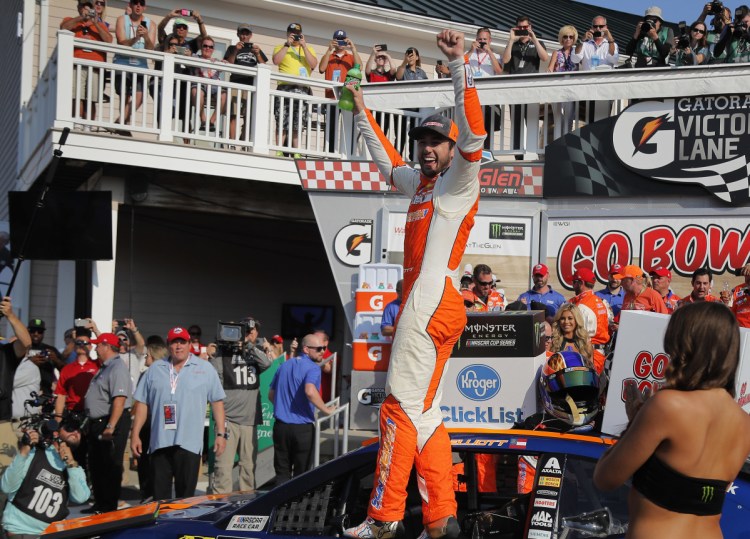 Chase Elliott, center, celebrates after holding off Martin Truex Jr. to earn his first NASCAR Cup Series win on Sunday in Watkins Glen, New York.