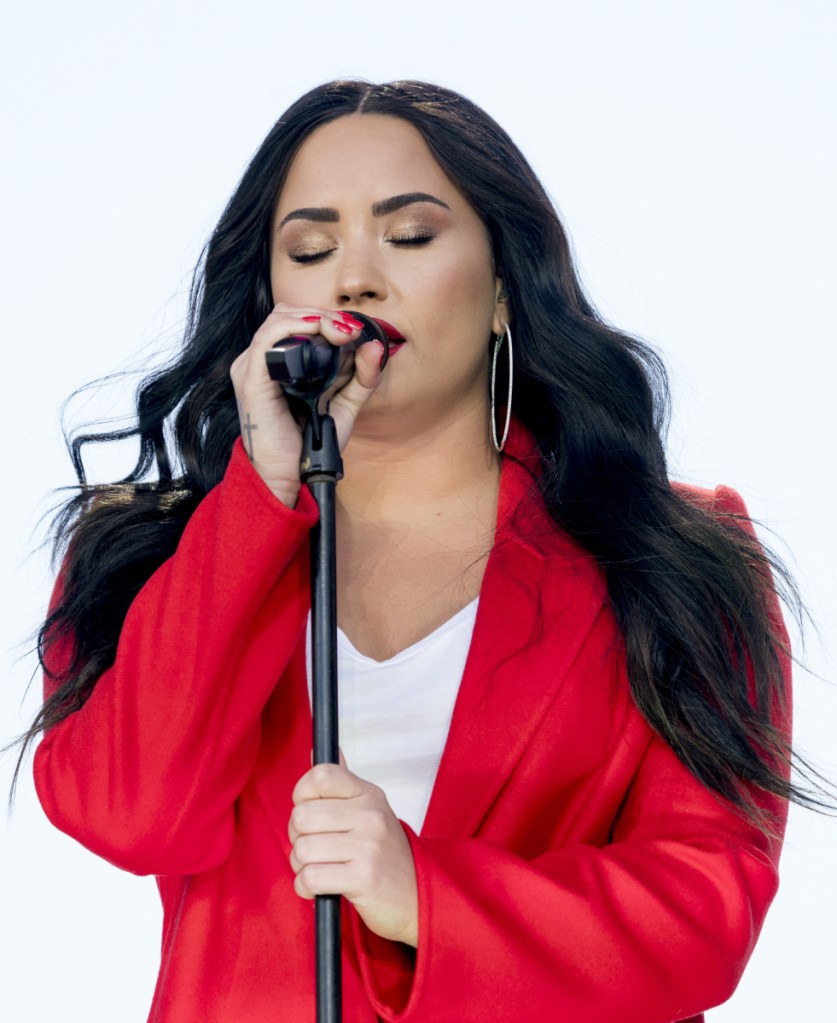Demi Lovato sings at a rally in March.