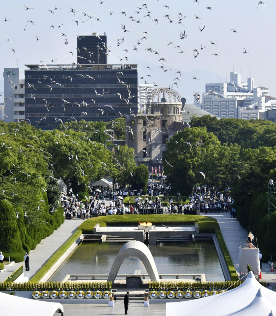 Doves fly over the cenotaph dedicated to the victims during a ceremony to mark the 73rd anniversary of the atomic bombing at Hiroshima Peace Memorial Park in Hiroshima.