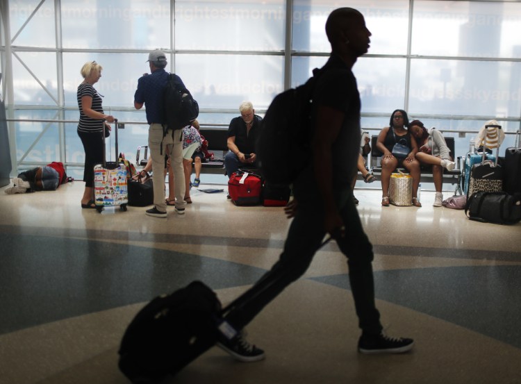 Travelers gather on benches to wait for flights as others make their way to their gate at the Fort Lauderdale-Hollywood International Airport in Florida. Consumer advocates see potential victories and setbacks in two bills before Congress.