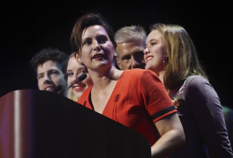 Michigan Democratic gubernatorial candidate Gretchen Whitmer stands with her family and addresses her supporters after winning the primary late Tuesday night in Detroit. Whitmer will face Republican Bill Schuette in November.