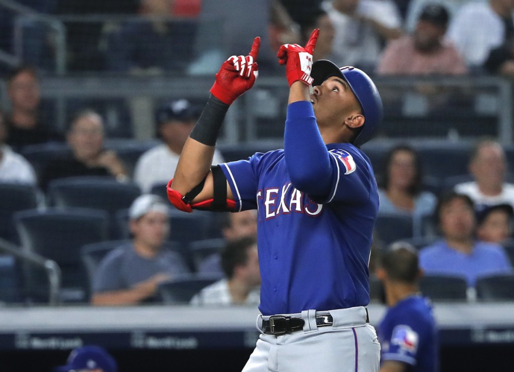 Ronald Guzman of the Texas Rangers celebrates while crossing the plate after hitting a home run in the fourth inning Friday night against the New York Yankees.